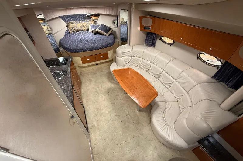 Slide: The Image of 2003 Formula 37 PC yacht interior with cozy seating, kitchenette, and sleeping area. - 13