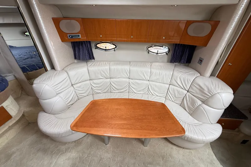 Slide: The Image of Luxurious interior of a 2003 Formula 37 PC yacht with leather seating and wooden table. - 14
