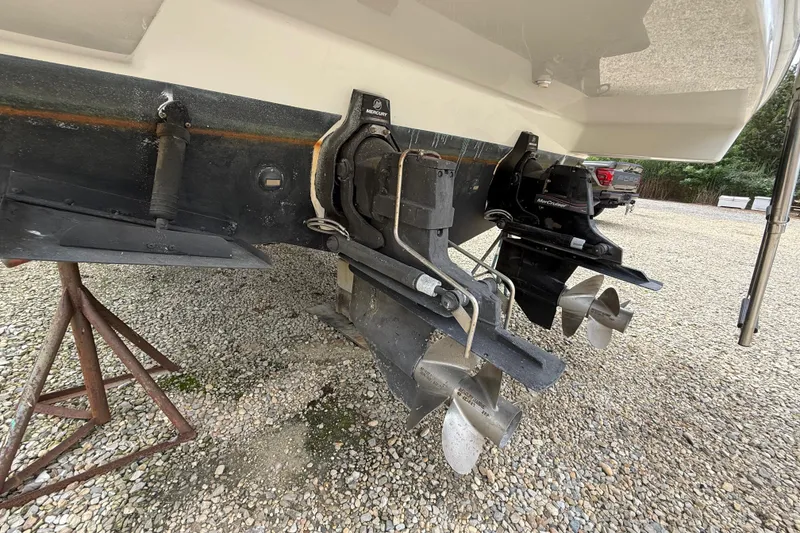 Slide: The Image of 2003 Formula 37 PC boat stern with dual propellers on gravel surface. - 22