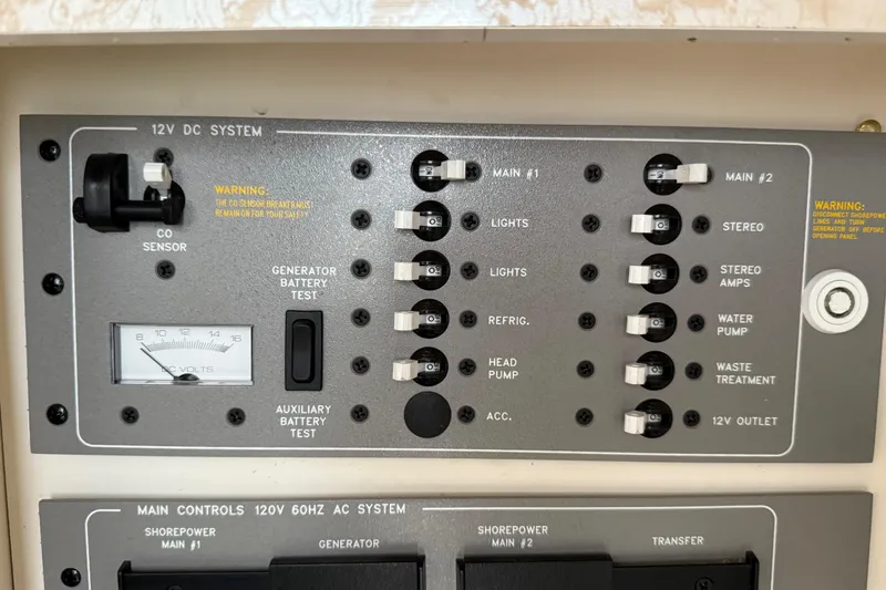 Slide: The Image of Control panel of a 2003 Formula 37 PC boat, featuring 12V DC system switches. - 24