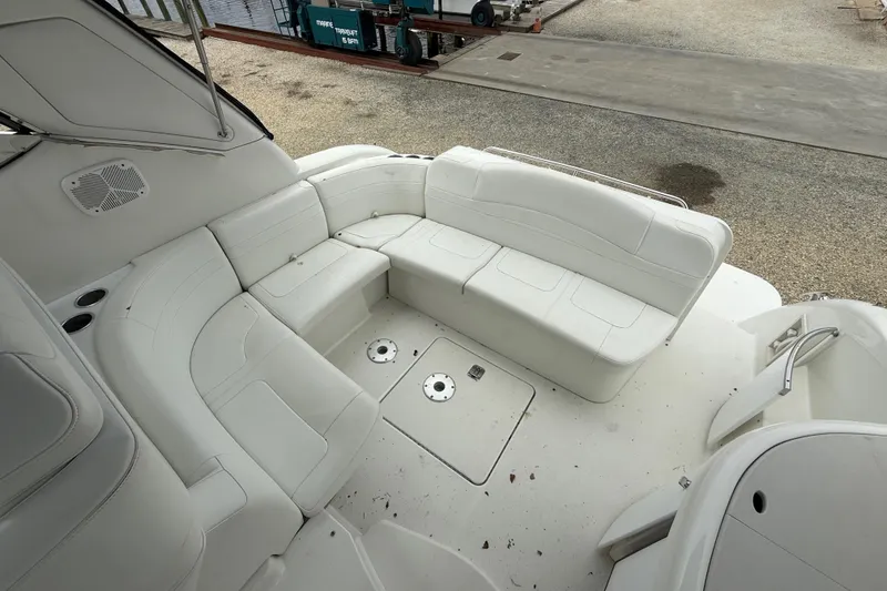 Slide: The Image of 2003 Formula 37 PC boat interior with white seating and cup holders. - 7