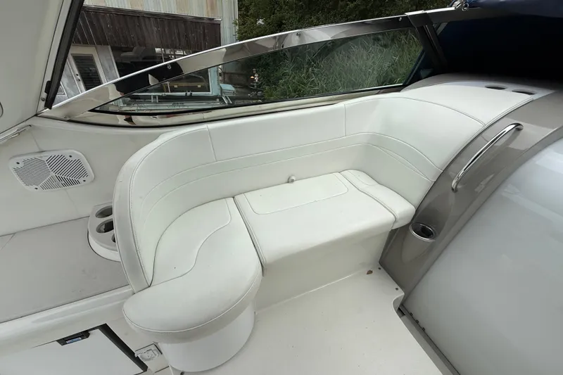 Slide: The Image of 2003 Formula 37 PC boat interior with white seating and cup holders. - 9