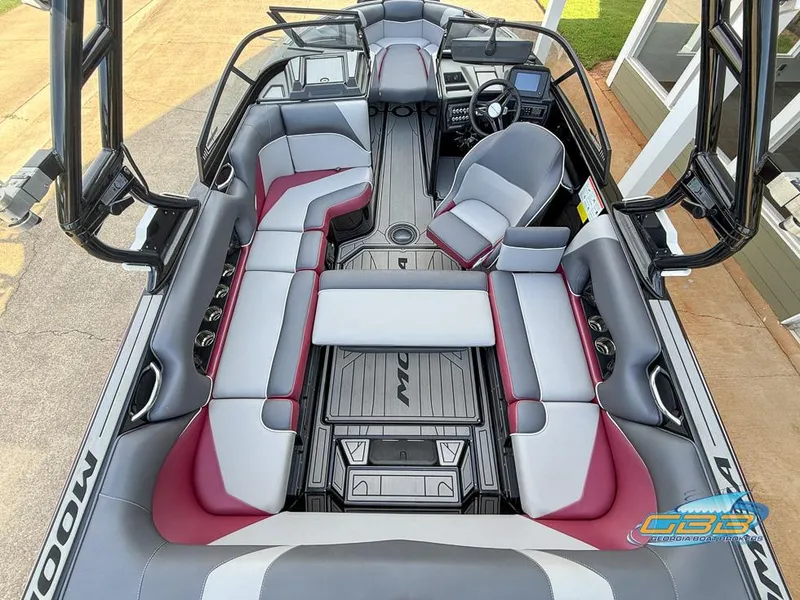 Slide: The Image of 2019 Moomba Craz boat interior with gray and red seating, modern dashboard, and spacious layout. - 11
