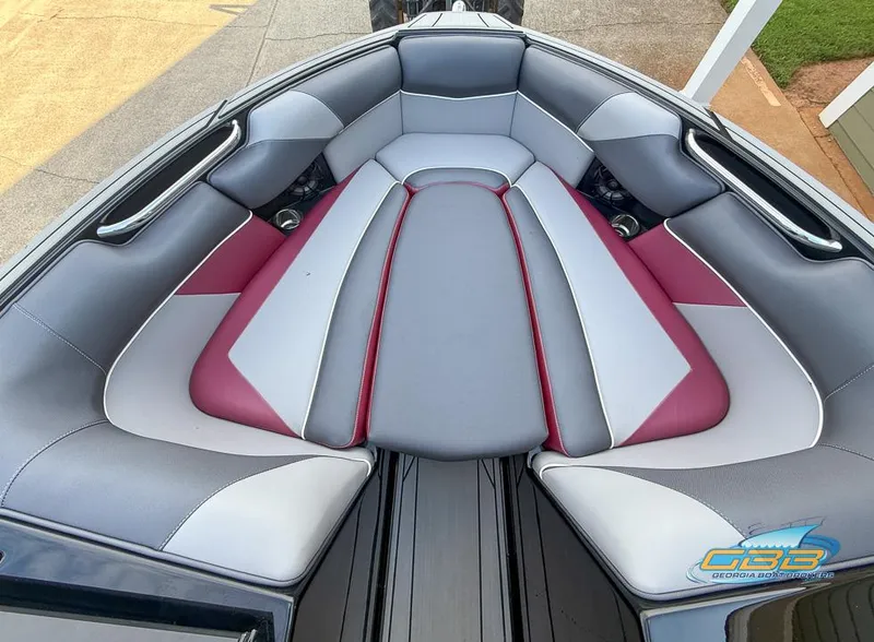 Slide: The Image of 2019 Moomba Craz boat interior with gray and red cushioned seating. - 12