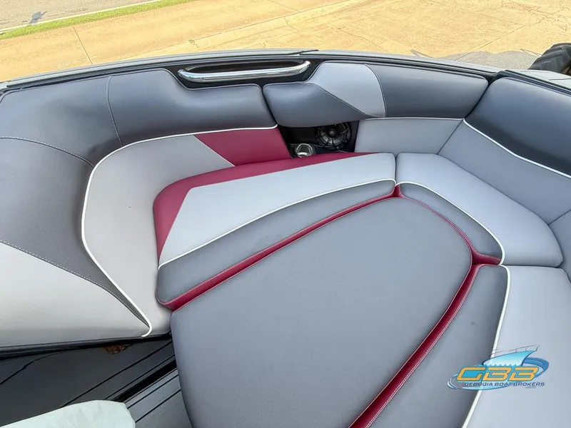 Slide: The Image of 2019 Moomba Craz boat interior with gray and red cushioned seating. - 18