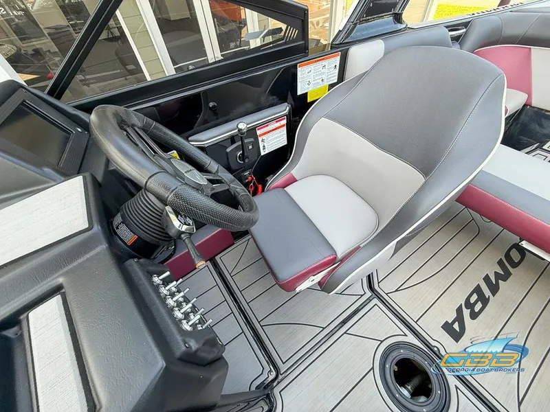 Slide: The Image of 2019 Moomba Craz boat interior with steering wheel and seating area. - 19