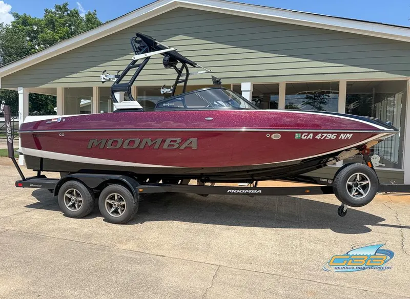 Slide: The Image of 2019 Moomba Craz boat on trailer, parked outside a house. - 2