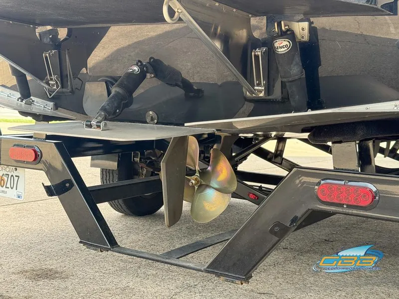 Slide: The Image of 2019 Moomba Craz boat trailer with propeller and Lenco trim tabs. - 25