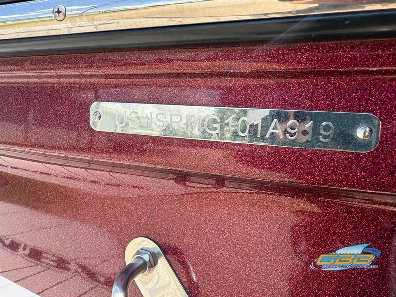 Slide: The Image of 2019 Moomba Craz boat hull with identification number plate, metallic red finish. - 31