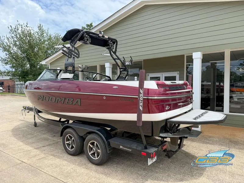 Slide: The Image of 2019 Moomba Craz boat on trailer, parked outside a building, showcasing sleek design. - 5