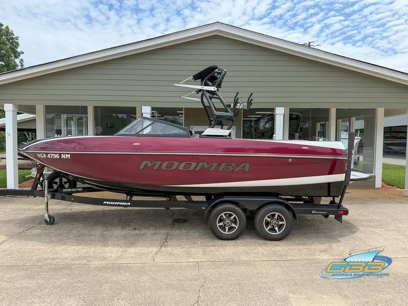 Slide: The Image of 2019 Moomba Craz boat on trailer, parked in front of a building. - 7