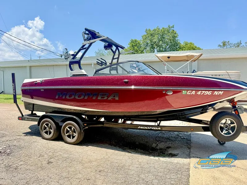 Slide: The Image of 2019 Moomba Craz boat on trailer, red exterior, parked outdoors. - 8