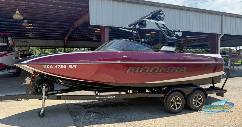 Slide: The Image of 2019 Moomba Craz boat on trailer, red exterior, parked in covered area. - 9