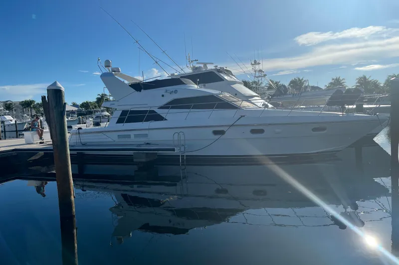 The Image of Luxury yacht Jefferson International 5300, 2001 model, docked at marina under clear blue sky. - 0