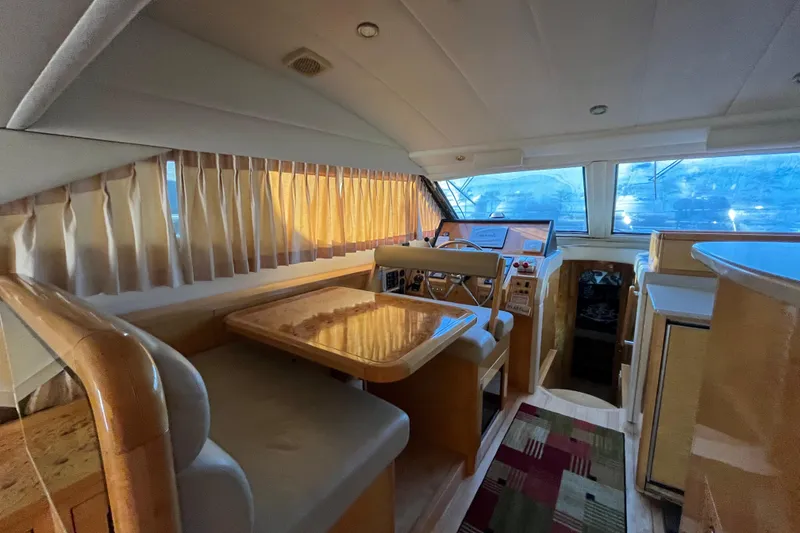 Slide: The Image of Interior of a 2001 Jefferson International 5300 yacht with dining area and helm. - 15