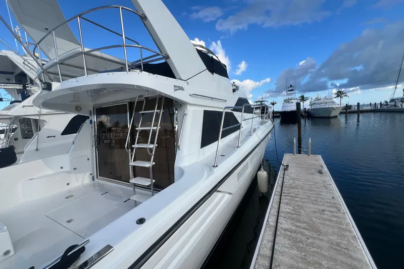 Slide: The Image of Luxury yacht docked at marina, Jefferson International 5300, 2001 model, under a clear blue sky. - 2