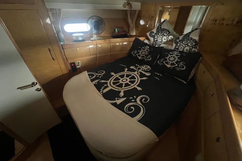 Slide: The Image of Cozy bedroom in 2001 Jefferson International 5300 yacht with nautical-themed bedding. - 22