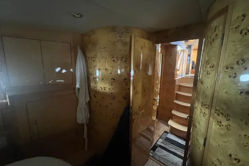 Slide: The Image of Luxurious interior of a 2001 Jefferson International 5300 yacht with wooden finishes and staircase. - 25