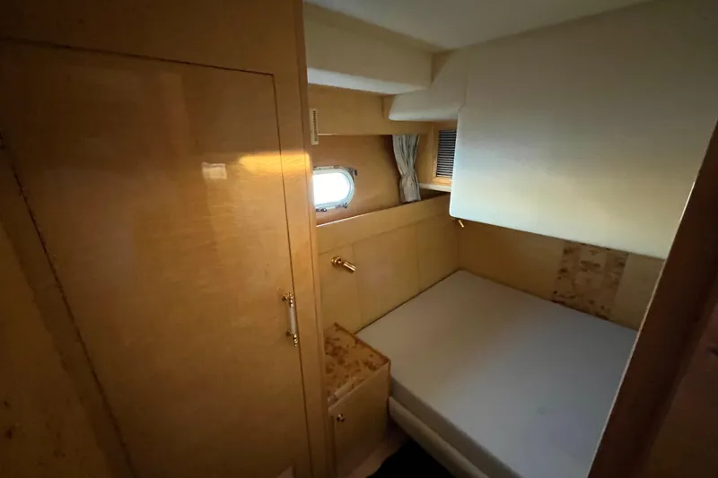Slide: The Image of Compact cabin interior of 2001 Jefferson International 5300 yacht with bed and window. - 29