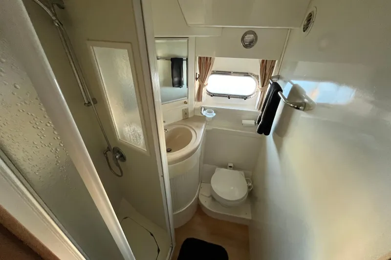 Slide: The Image of Compact bathroom in a 2001 Jefferson International 5300, featuring shower, sink, and toilet. - 31