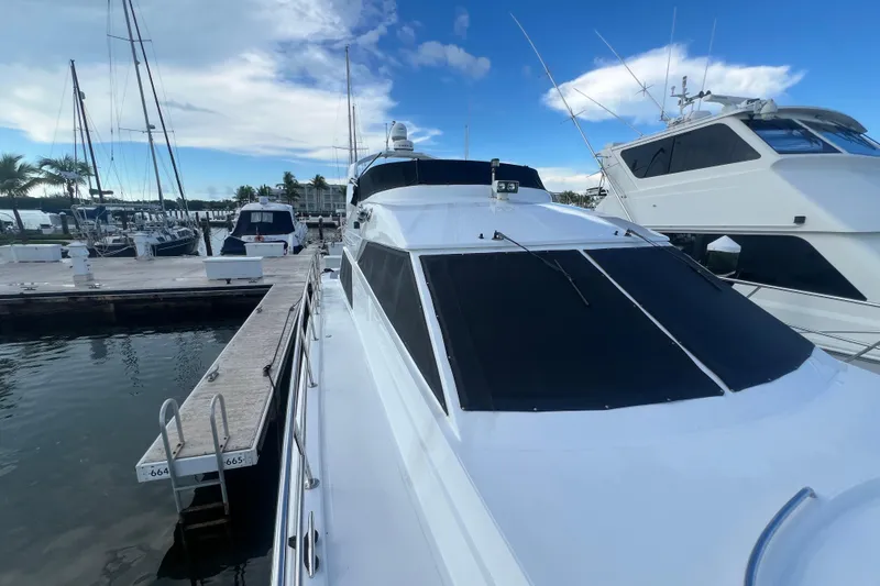 Slide: The Image of 2001 Jefferson International 5300 yacht docked at marina under clear blue sky. - 6