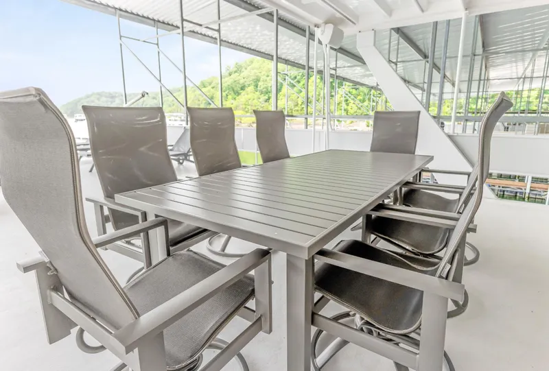 Slide: The Image of Outdoor dining area on 1997 Sumerset 18 x 93 houseboat with modern chairs and table. - 11