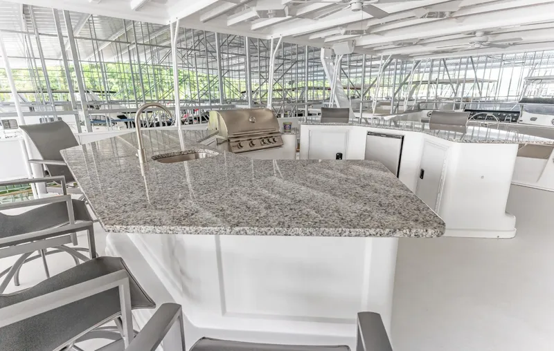 Slide: The Image of Luxurious 1997 Sumerset 18 x 93 houseboat with granite countertop and outdoor kitchen amenities. - 12