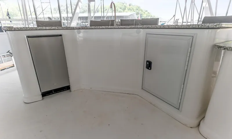 Slide: The Image of 1997 Sumerset 18 x 93 houseboat interior with sleek white cabinetry and granite countertop. - 13