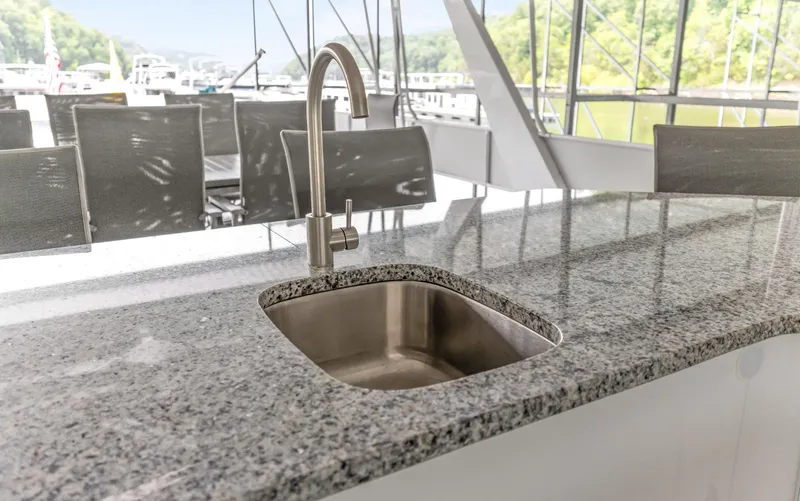 Slide: The Image of Granite countertop with sink on 1997 Sumerset 18 x 93 houseboat, outdoor seating in background. - 15