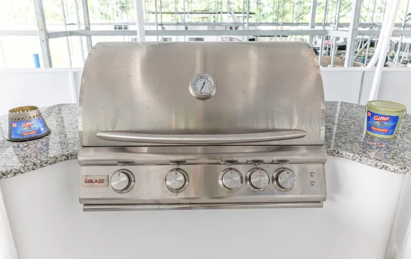 Slide: The Image of Outdoor stainless steel grill on Sumerset 18 x 93 houseboat, 1997 model, with insect repellent nearby. - 16