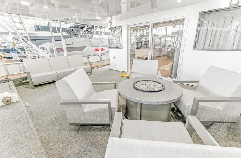 Slide: The Image of Outdoor seating area on a 1997 Sumerset 18 x 93 houseboat with modern furniture. - 21