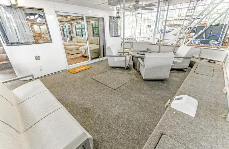 Slide: The Image of Spacious 1997 Sumerset 18 x 93 houseboat interior with seating and sliding glass doors. - 22