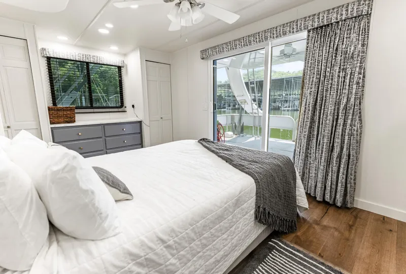 Slide: The Image of Bedroom interior of 1997 Sumerset 18 x 93 houseboat with modern decor and lake view. - 31