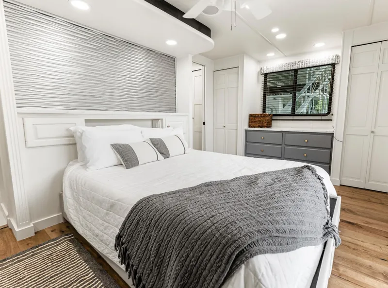 Slide: The Image of Cozy bedroom in a 1997 Sumerset 18 x 93 houseboat with modern decor and natural light. - 32