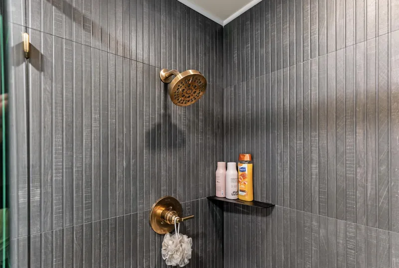 Slide: The Image of Luxurious shower with modern fixtures and toiletries on a shelf, Sumerset 18 x 93, 1997. - 34