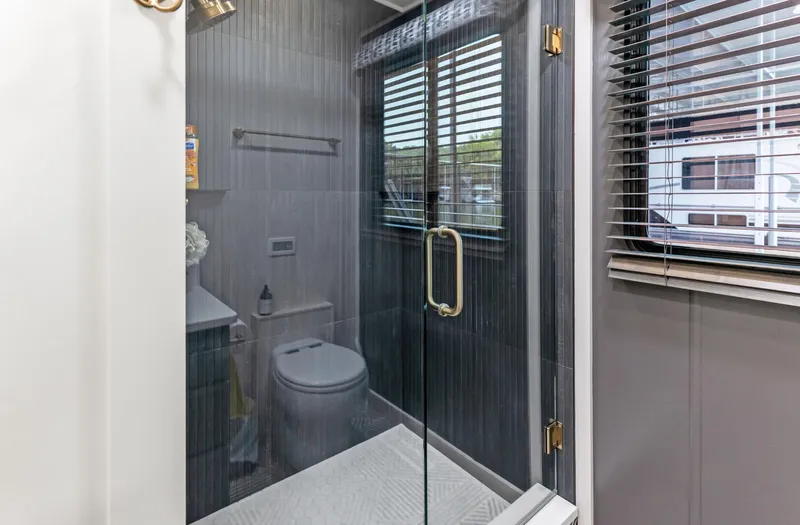 Slide: The Image of Bathroom in 1997 Sumerset 18 x 93 houseboat with glass shower and modern fixtures. - 36