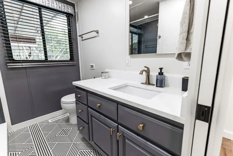 Slide: The Image of Modern bathroom in 1997 Sumerset 18 x 93 houseboat with sleek vanity and geometric flooring. - 37