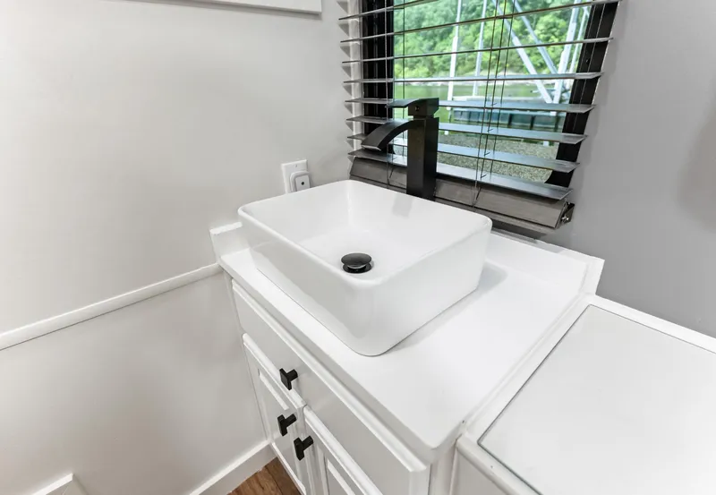 Slide: The Image of White bathroom sink with modern faucet in Sumerset 18 x 93 houseboat, 1997 model. - 39