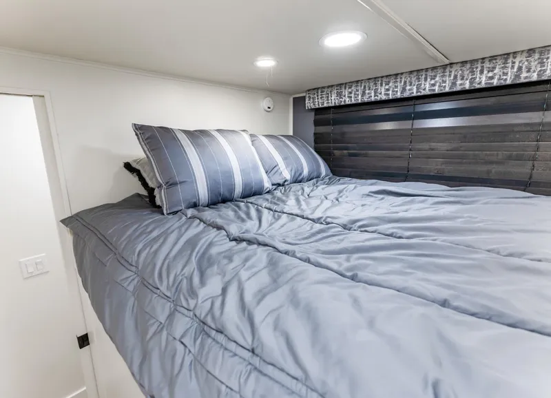 Slide: The Image of Cozy bedroom in 1997 Sumerset 18 x 93 houseboat with striped bedding and modern decor. - 41