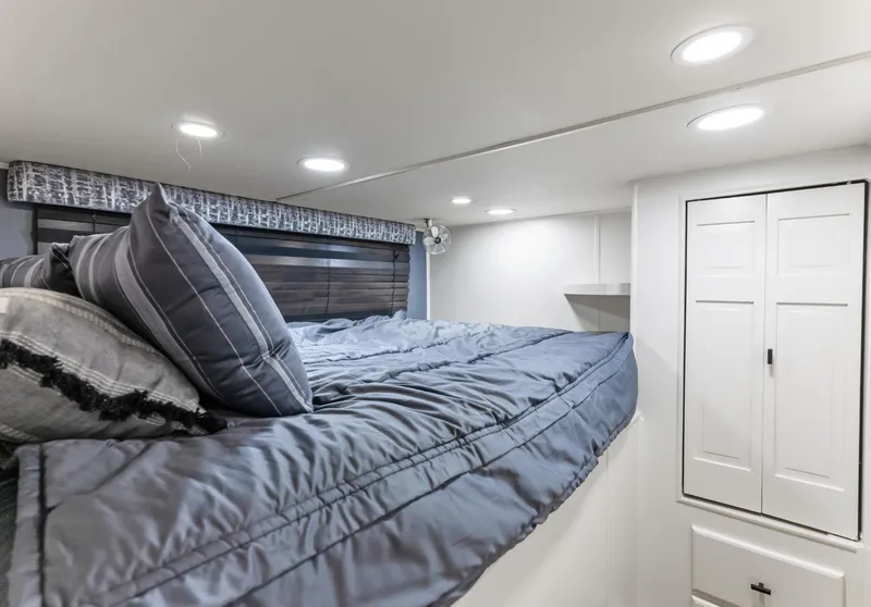 Slide: The Image of Cozy bedroom in 1997 Sumerset 18 x 93 houseboat with blue bedding and modern lighting. - 42