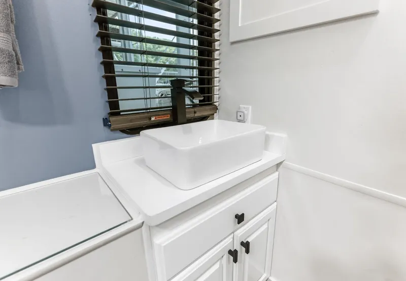 Slide: The Image of White bathroom sink with modern faucet on Sumerset 18 x 93 houseboat, 1997 model. - 43