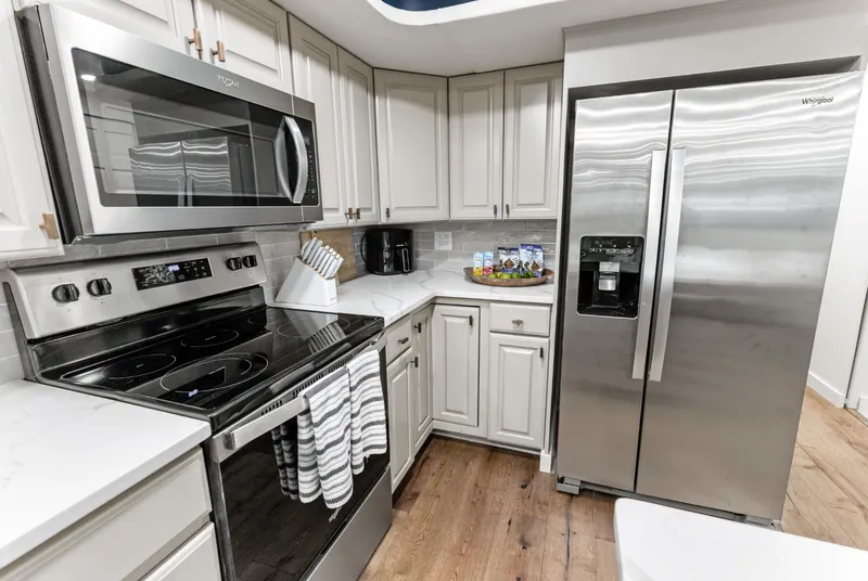 Slide: The Image of Modern kitchen with stainless steel appliances in a 1997 Sumerset 18 x 93 houseboat. - 49