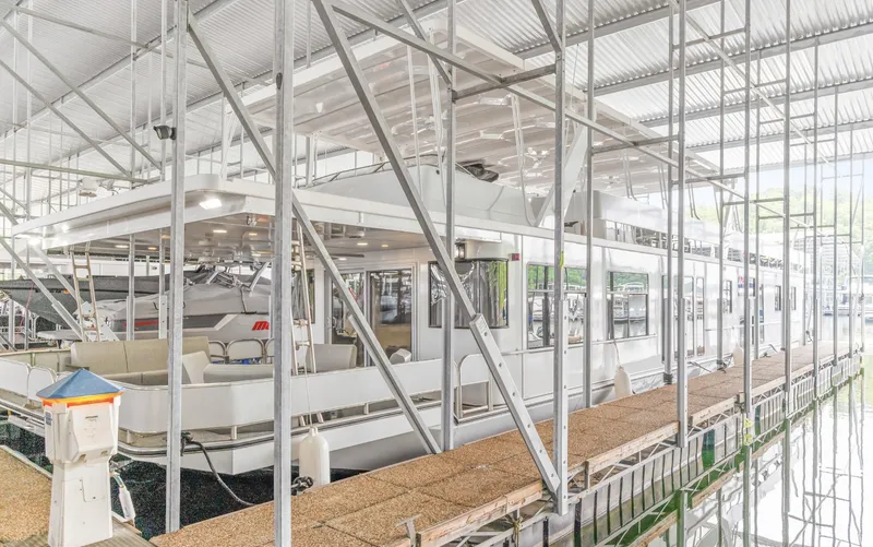 Slide: The Image of Houseboat docked in marina, Sumerset 18 x 93, 1997 model, under metal canopy. - 7