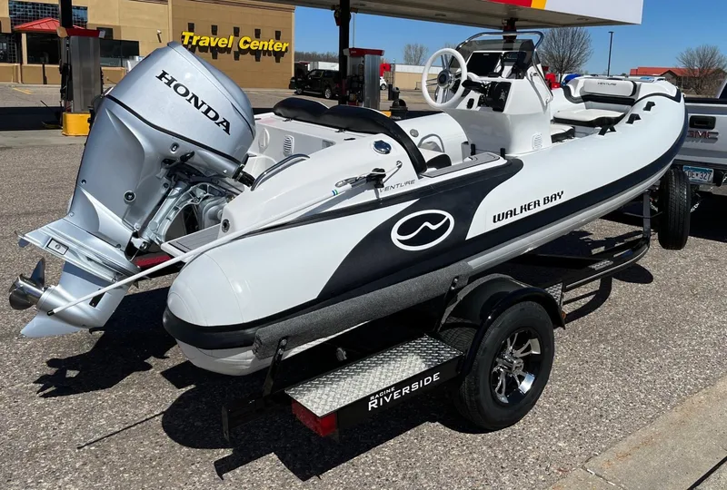 Slide: The Image of 2022 Walker Bay Venture 14 boat with Honda motor on trailer at travel center. - 13