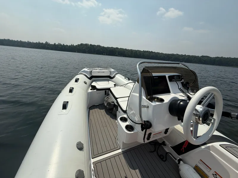 Slide: The Image of 2022 Walker Bay Venture 14 boat interior on a calm lake. - 15