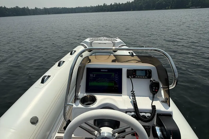 Slide: The Image of 2022 Walker Bay Venture 14 boat dashboard on a calm lake. - 23
