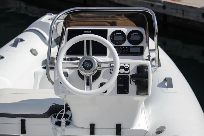 Slide: The Image of Manufacturer Provided Image: 2022 Walker Bay Venture 14 boat dashboard with steering wheel and control panel. - 5