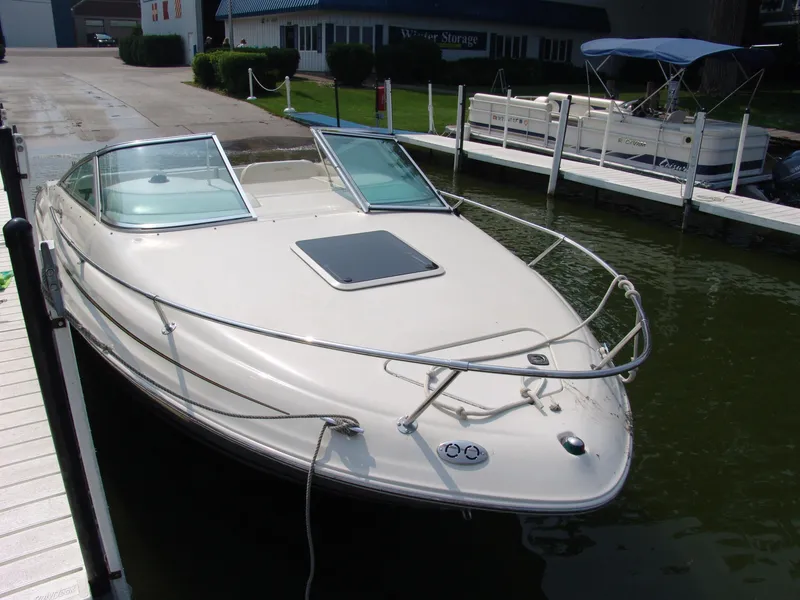 Slide: The Image of 2000 Sea Ray 215 Express Cruiser docked at marina, front view. - 1