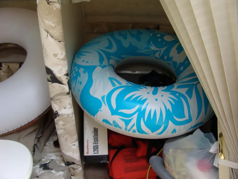 Slide: The Image of Storage area in a 2000 Sea Ray 215 Express Cruiser with inflatable tube and life jacket. - 16