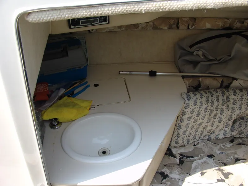 Slide: The Image of Interior cabin of 2000 Sea Ray 215 Express Cruiser with sink and storage. - 17